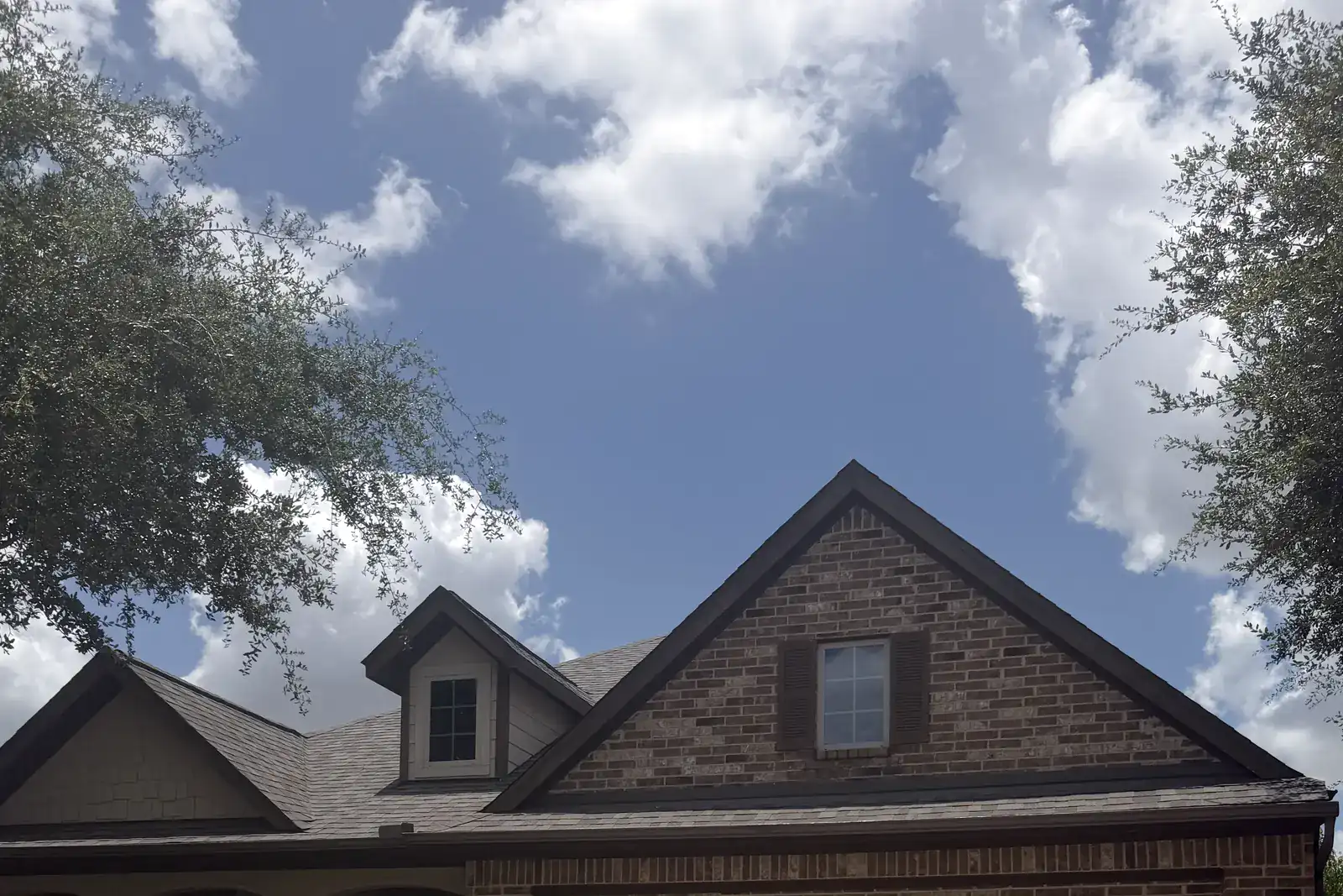Residential roofline and gables documented from ground level.